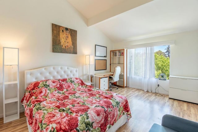 bedroom featuring lofted ceiling with beams and light wood-type flooring