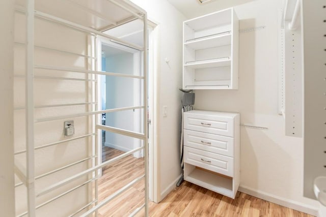 spacious closet with light hardwood / wood-style flooring