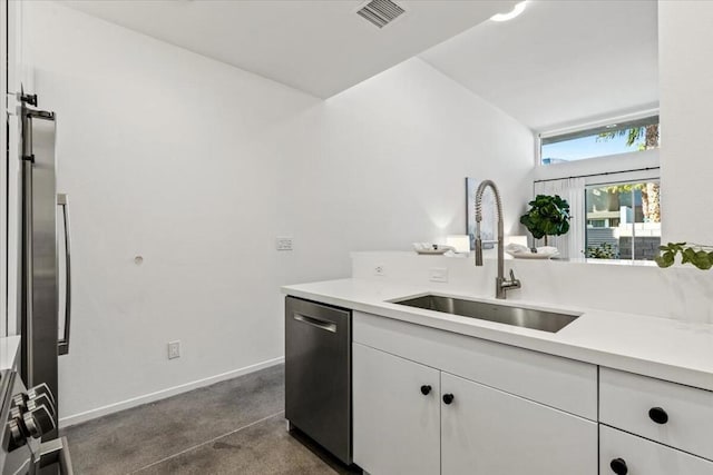 kitchen featuring appliances with stainless steel finishes, white cabinets, and sink