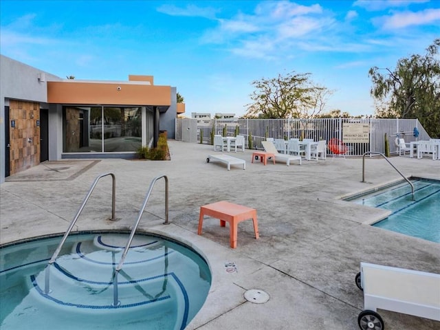 view of pool featuring a hot tub and a patio