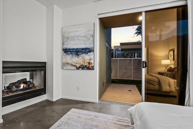 bedroom featuring a multi sided fireplace