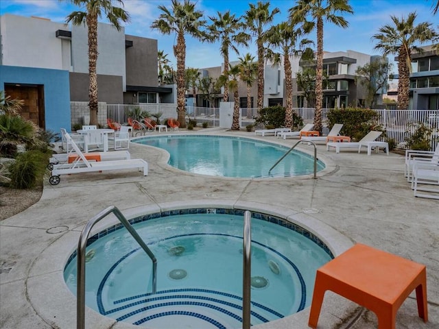 view of swimming pool featuring a community hot tub and a patio area