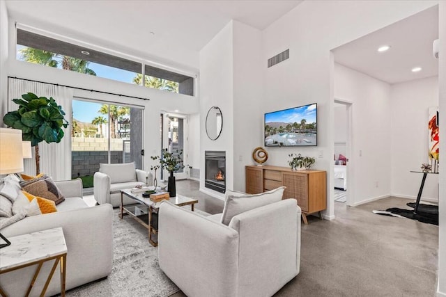 living room featuring a towering ceiling