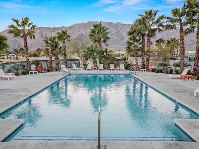 view of pool featuring a mountain view and a patio