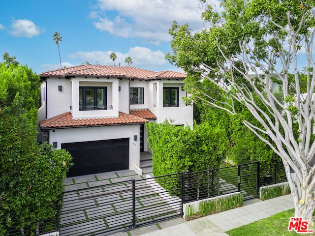 mediterranean / spanish house featuring a garage