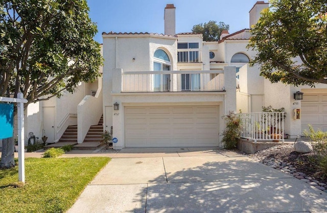 mediterranean / spanish-style house with a garage and a balcony