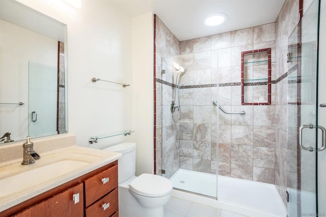 bathroom featuring toilet, vanity, an enclosed shower, and tile patterned flooring