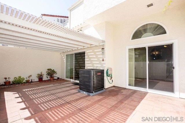 view of patio / terrace featuring cooling unit and a pergola