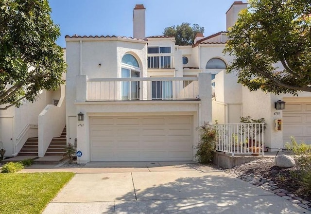 view of front facade with a balcony and a garage