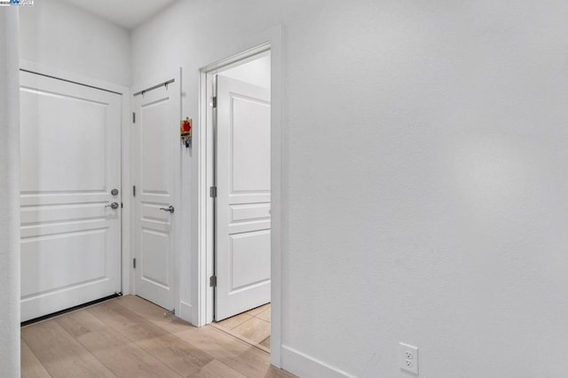 hall with light wood-type flooring