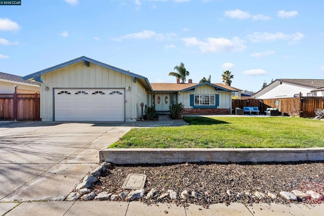 ranch-style home with a front yard and a garage