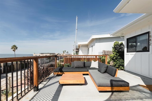 wooden deck featuring an outdoor hangout area and a water view