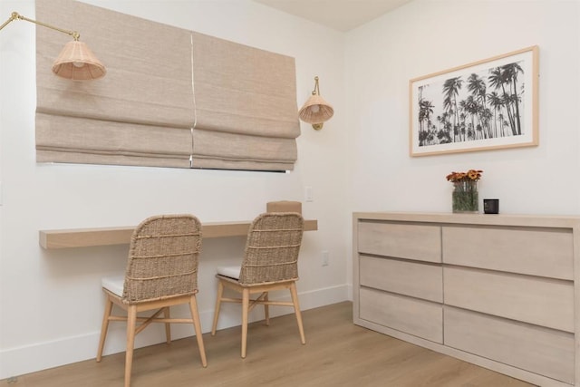 office featuring light wood-type flooring and baseboards