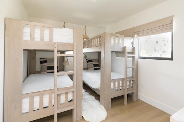 bedroom with baseboards and wood finished floors