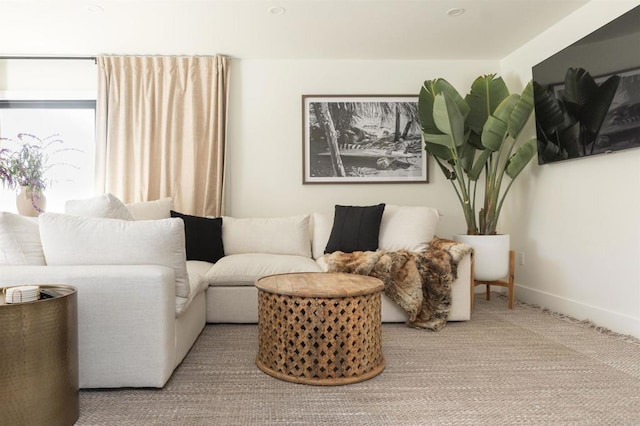 sitting room with carpet and baseboards