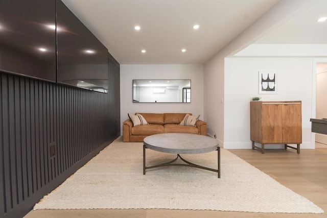 living area featuring light wood-style floors, baseboards, and recessed lighting