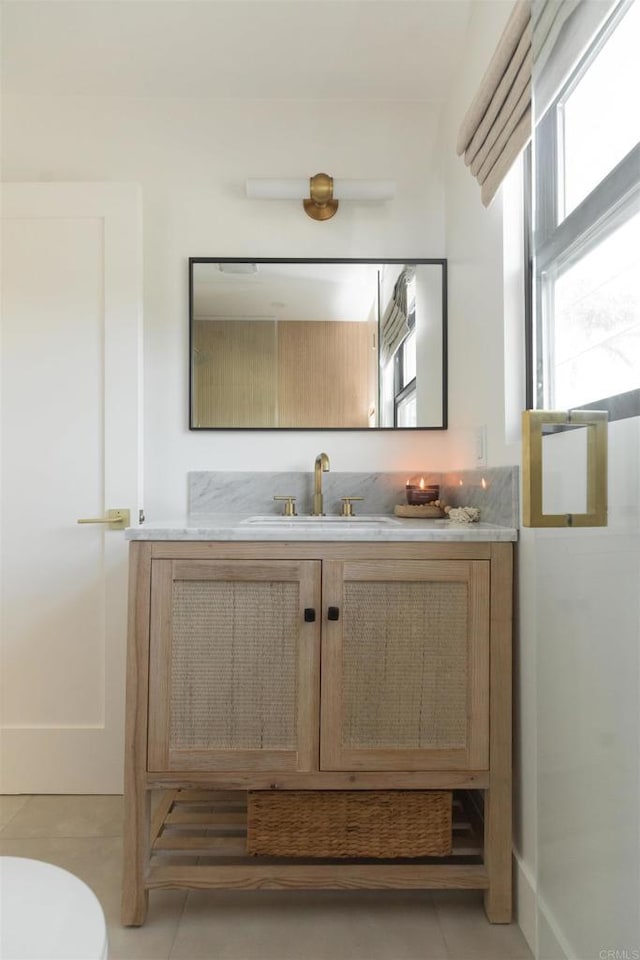 bathroom with plenty of natural light, vanity, and tile patterned floors