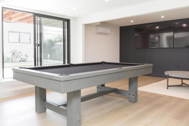 game room featuring light wood finished floors, pool table, a wall of windows, an AC wall unit, and recessed lighting