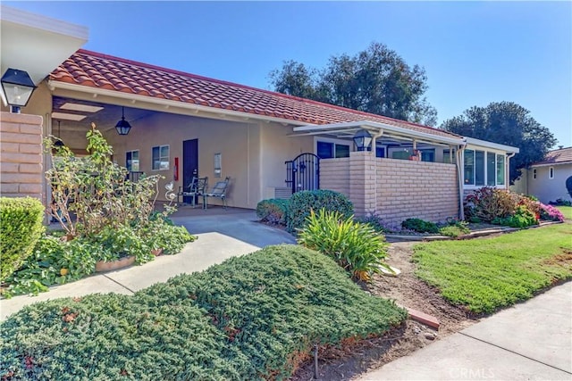 mediterranean / spanish-style house with a patio area