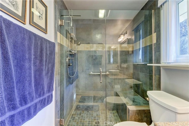 bathroom featuring toilet and walk in shower