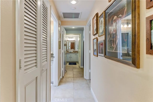 hall with light tile patterned floors