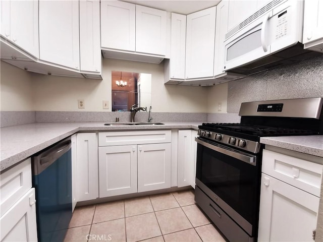 kitchen with stainless steel gas range oven, dishwashing machine, white cabinets, and light tile patterned floors