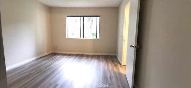 unfurnished room featuring hardwood / wood-style floors