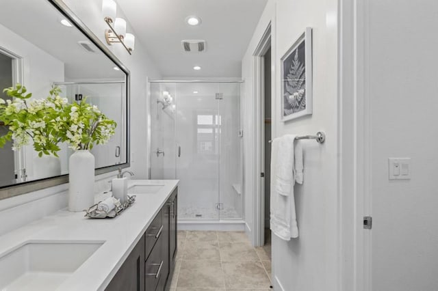 bathroom featuring a shower with door, tile patterned floors, vanity, and an inviting chandelier