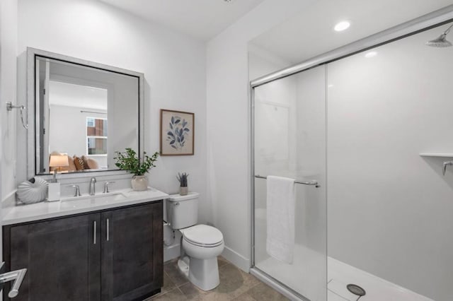 bathroom with an enclosed shower, vanity, and toilet