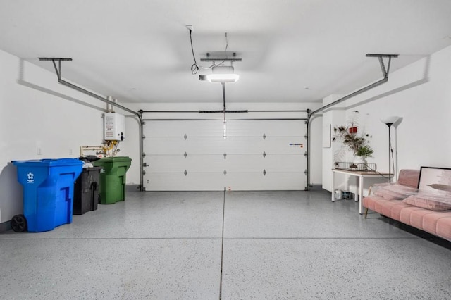 garage featuring water heater and a garage door opener