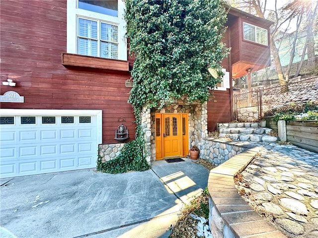 doorway to property with a garage