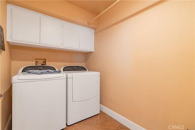 laundry area featuring cabinets, independent washer and dryer, and light tile patterned floors