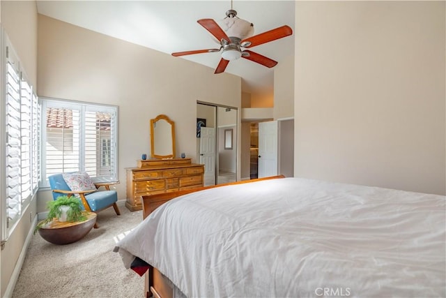 carpeted bedroom with lofted ceiling, a closet, and ceiling fan