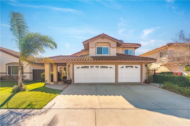 mediterranean / spanish house with a front lawn and a garage