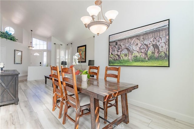 dining room with vaulted ceiling and a notable chandelier