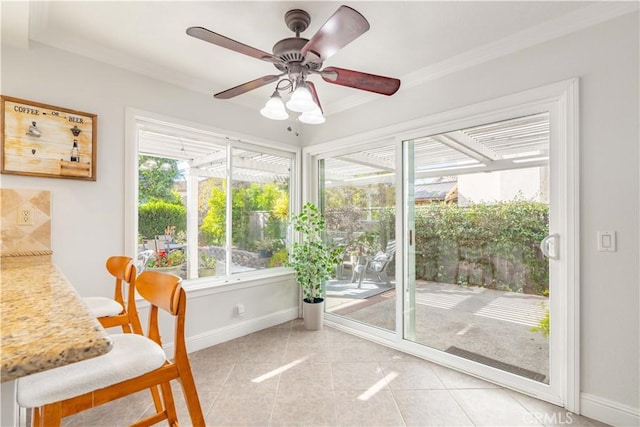 sunroom / solarium featuring ceiling fan