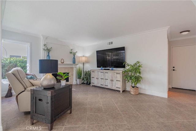 living room featuring a fireplace and crown molding