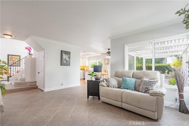 tiled living room with ornamental molding and ceiling fan