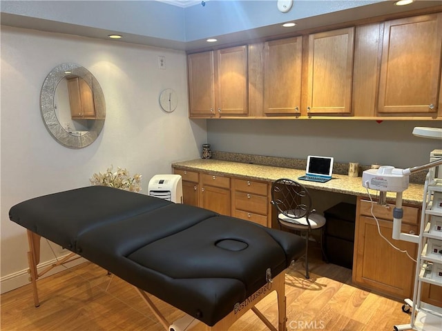 office featuring built in desk and light hardwood / wood-style flooring