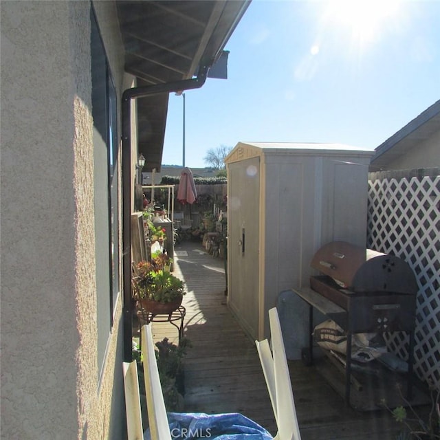 exterior space featuring a deck and a shed