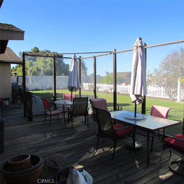 wooden terrace with a lawn