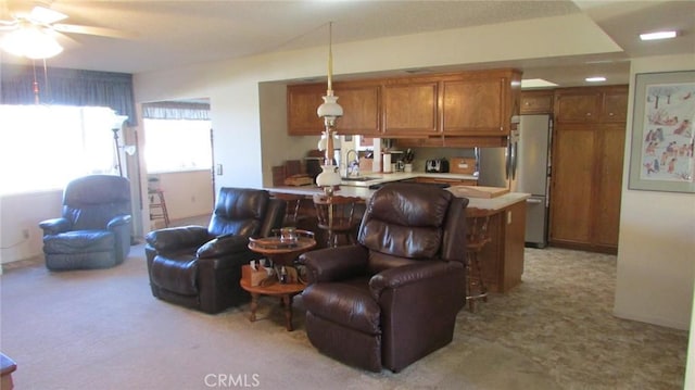 carpeted living room featuring ceiling fan and sink