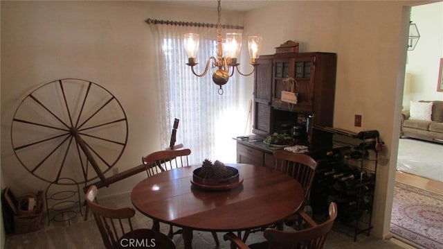 dining space featuring a chandelier and a healthy amount of sunlight