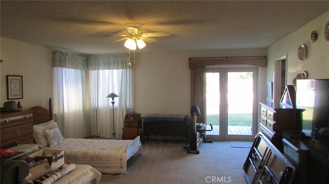 carpeted bedroom featuring access to outside, a textured ceiling, and ceiling fan