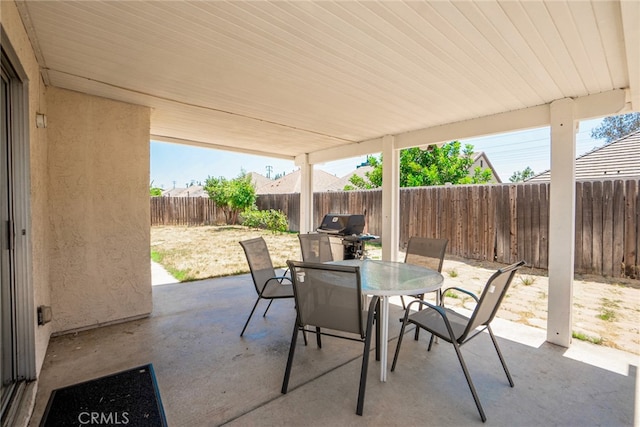 view of patio with a fenced backyard and outdoor dining space