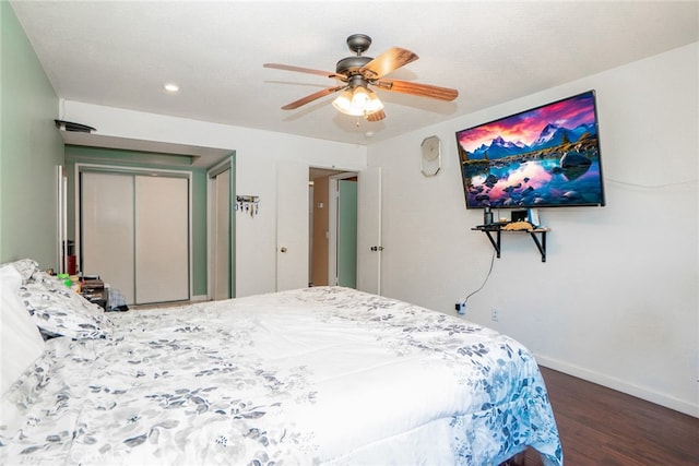 bedroom with a ceiling fan, wood finished floors, and baseboards