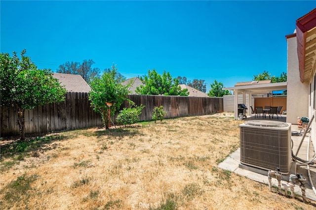 view of yard with a patio, central AC, and a fenced backyard