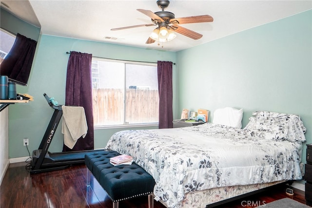 bedroom with wood finished floors, baseboards, and ceiling fan