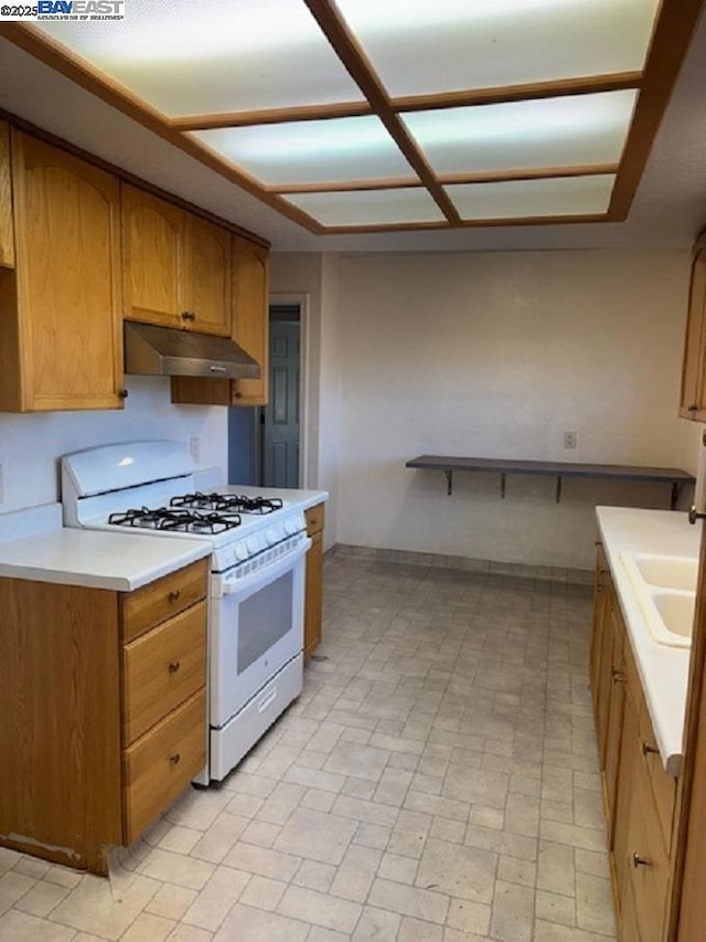 kitchen with sink and white gas range