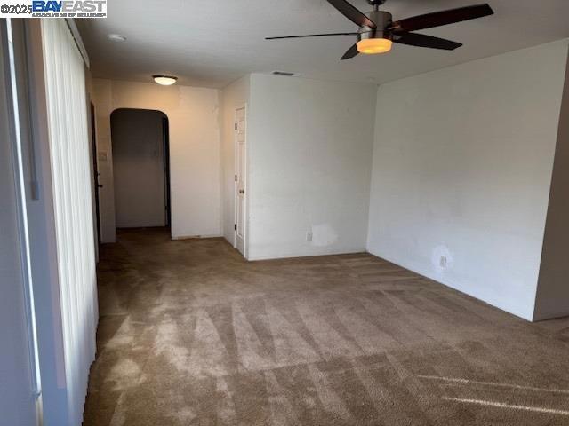 spare room featuring carpet floors and ceiling fan